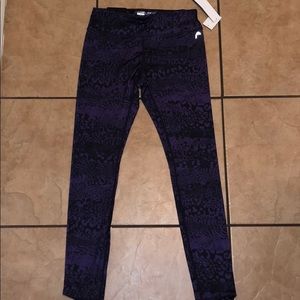 Tight fitted purple leggings. Brand Head.